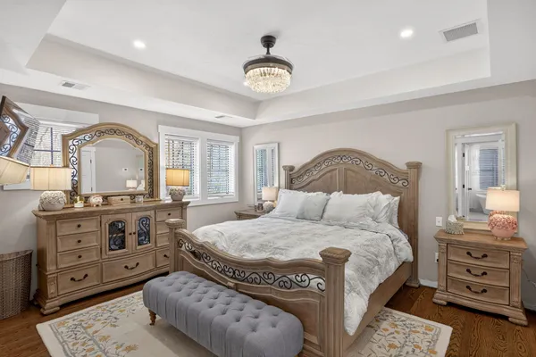 a bedroom with furniture and a flat screen tv