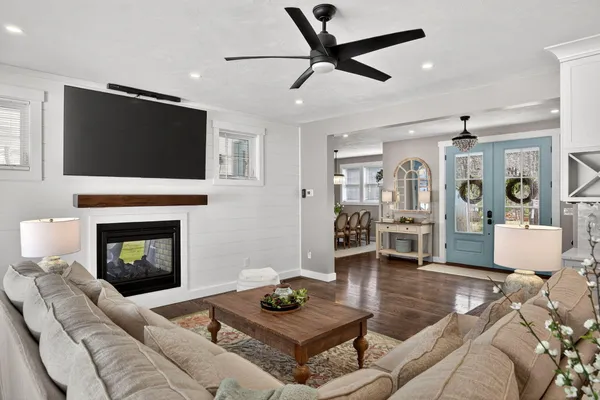 a living room with furniture and kitchen view
