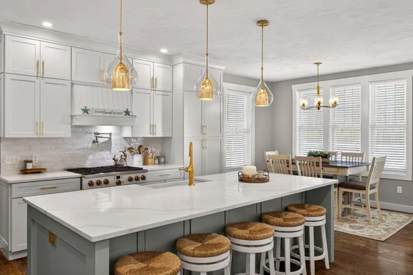 a kitchen with stainless steel appliances granite countertop a sink and a refrigerator