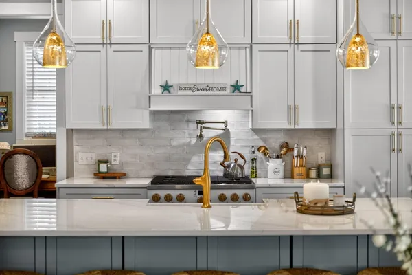 a kitchen with stainless steel appliances granite countertop a refrigerator and a stove