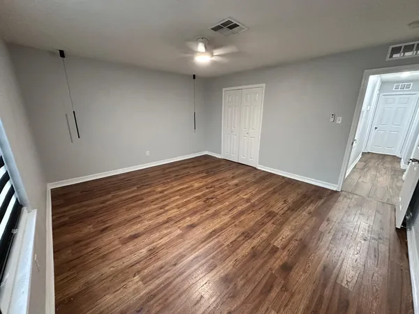 wooden floor in an empty room with a window