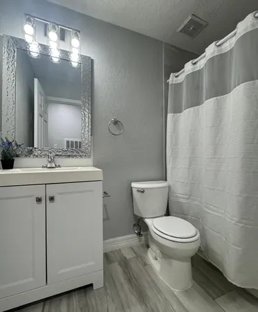 a bathroom with a toilet sink and shower