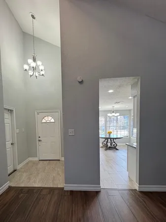 a view of a livingroom with hardwood floor and a kitchen