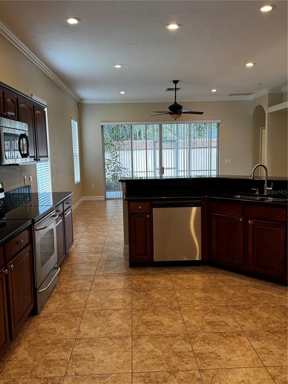 6871 Eagle Ridge Loop Lakeland, FL 33813 - Photo 20 of 42 a kitchen with granite countertop a stove a sink and a refrigerator
