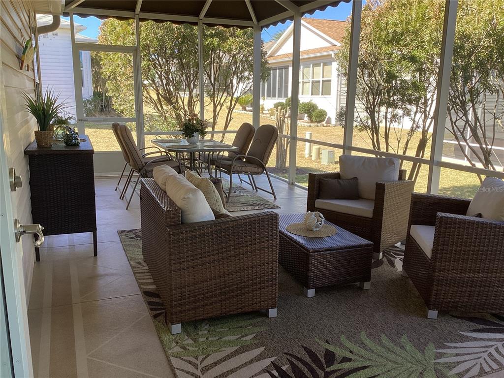 457 Alora Street The Villages, FL 32162 - Photo 2 of 2 a outdoor living space with furniture and garden view