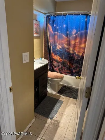 a bathroom with a toilet and a shower curtain