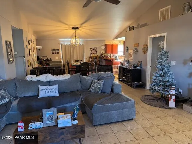 a living room with furniture flowerpot and a chandelier