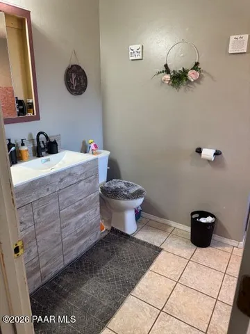a bathroom with a toilet and a mirror