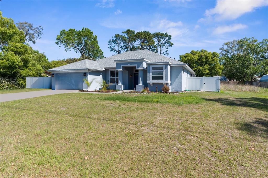8604 Vicksburg Road Spring Hill, FL 34608 - Photo 1 of 1 front view of a house with a yard