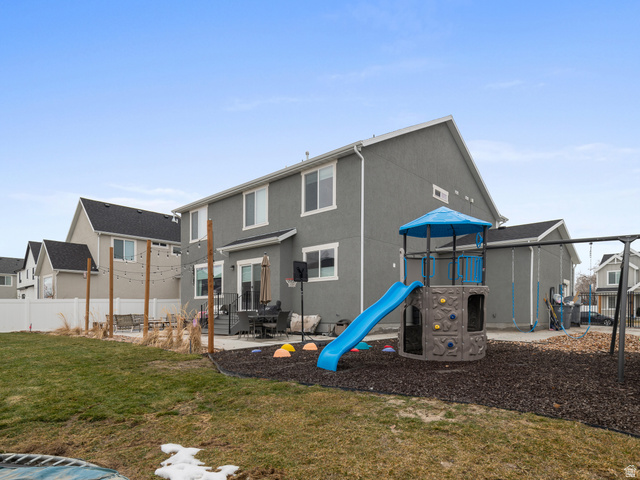 627 South Meade Street Mapleton, UT 84664 - Photo 27 of 48 Rear exterior featuring a spacious patio, sliding glass door, and a white privacy fence