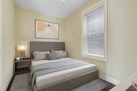 a living room with a baby crib furniture and a window