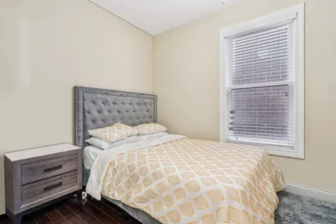 a bedroom with a bed and a dresser