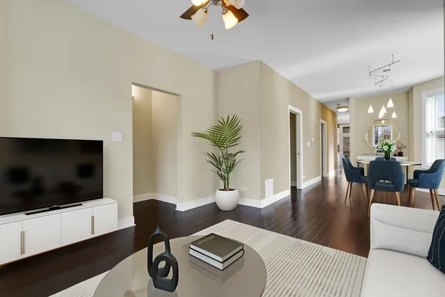 a kitchen with stainless steel appliances granite countertop a stove top oven a sink dishwasher a refrigerator and a microwave oven with wooden floor