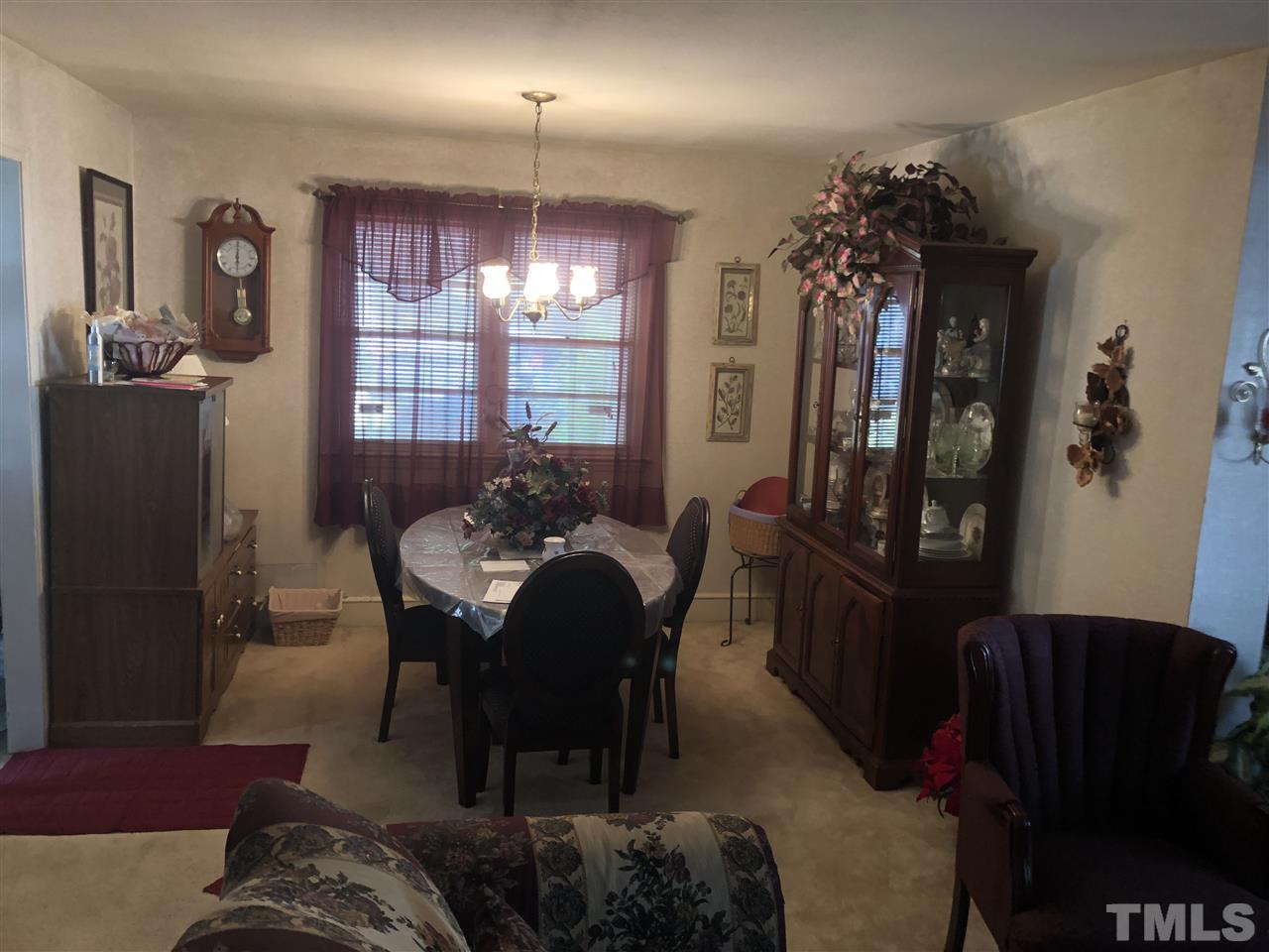 308 Shellum Street Raleigh, NC 27610 - Photo 5 of 16 a view of a dining room with furniture and chandelier