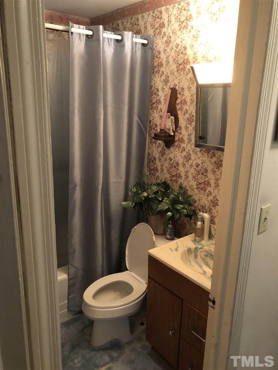 308 Shellum Street Raleigh, NC 27610 - Photo 10 of 16 a bathroom with a sink and toilet