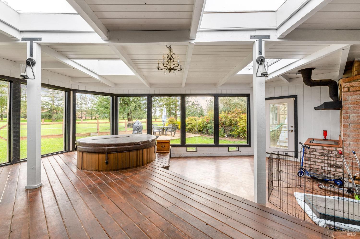Beautiful enclosed sunroom with a built-in hot tub, and barbeque area.  What a relaxing place to end your day with a spectacular view of the Foxtail North Course.