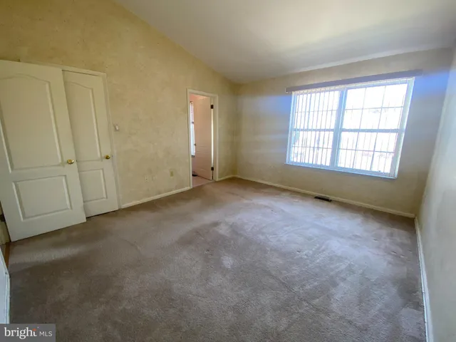 an empty room with a empty space and windows