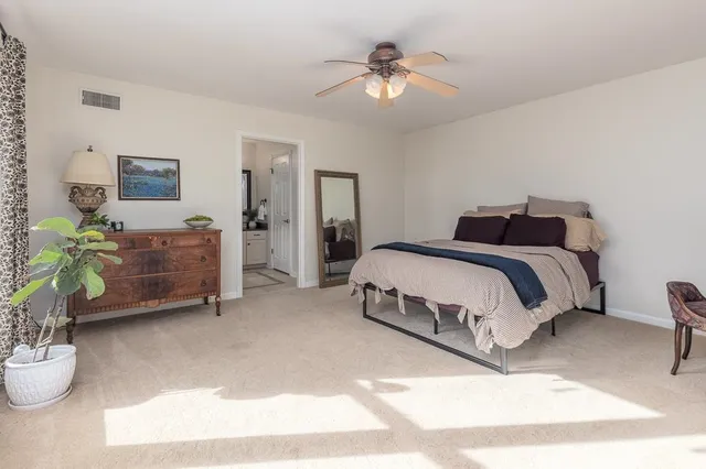 a view of an empty room with a cabinet and a window
