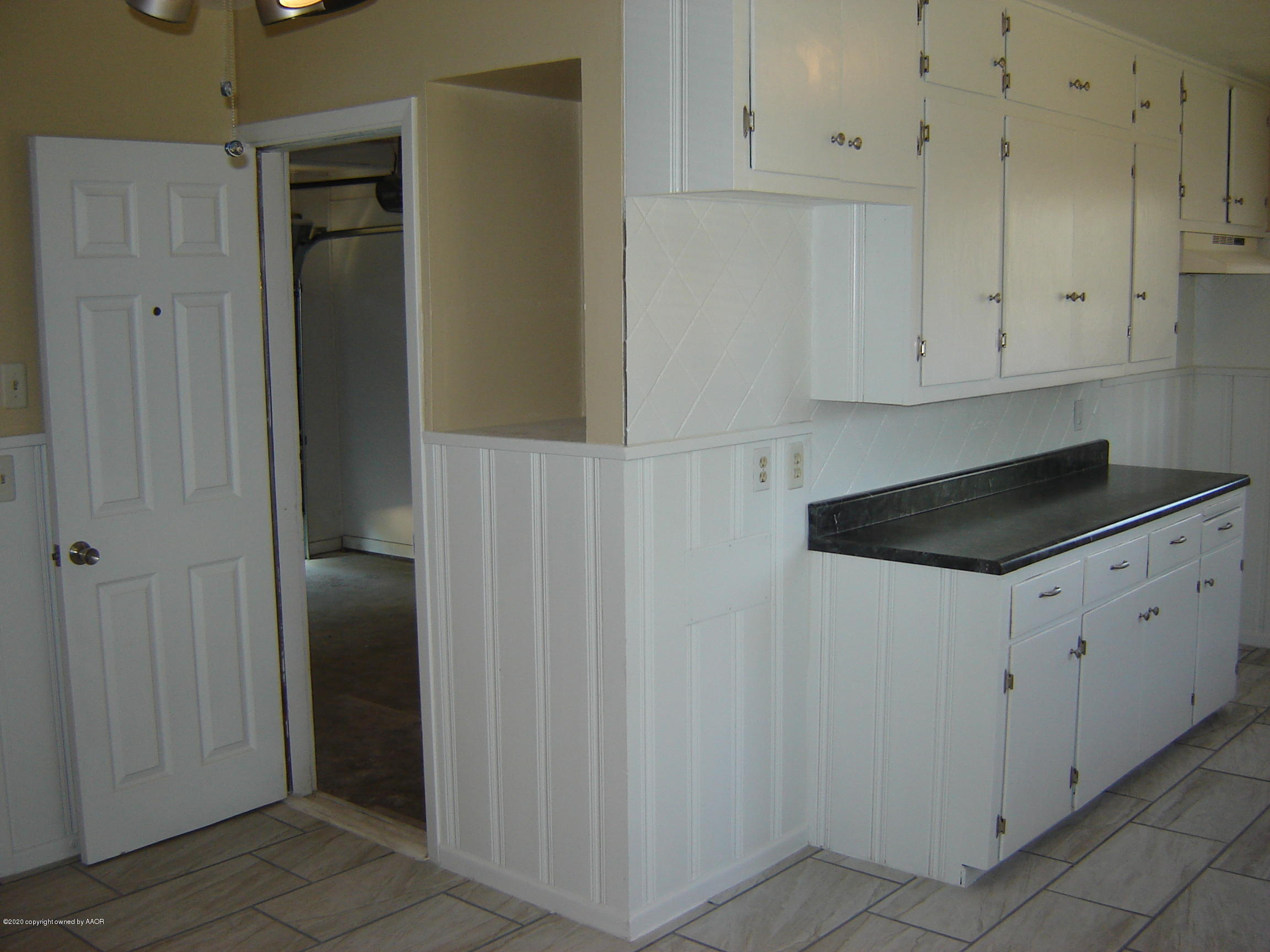 4013 Crockett Street Amarillo, TX 79110 - Photo 11 of 28 a kitchen with white cabinets