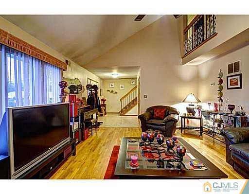 119 Dover Road Colonia, NJ 07067 - Photo 3 of 25 a living room with furniture and a flat screen tv
