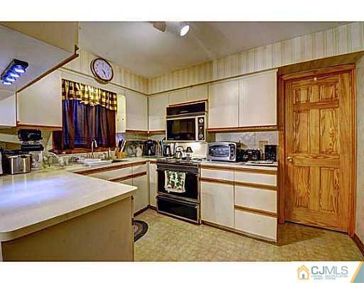 119 Dover Road Colonia, NJ 07067 - Photo 6 of 25 a kitchen with stainless steel appliances granite countertop a stove refrigerator and cabinets