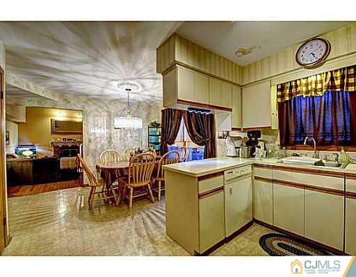 119 Dover Road Colonia, NJ 07067 - Photo 7 of 25 a kitchen with a sink cabinets and wooden floor