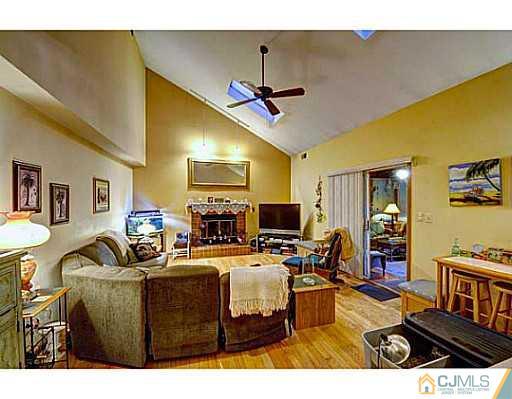 119 Dover Road Colonia, NJ 07067 - Photo 8 of 25 a living room with furniture and a flat screen tv