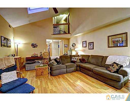 119 Dover Road Colonia, NJ 07067 - Photo 9 of 25 a living room with furniture and painting on the wall