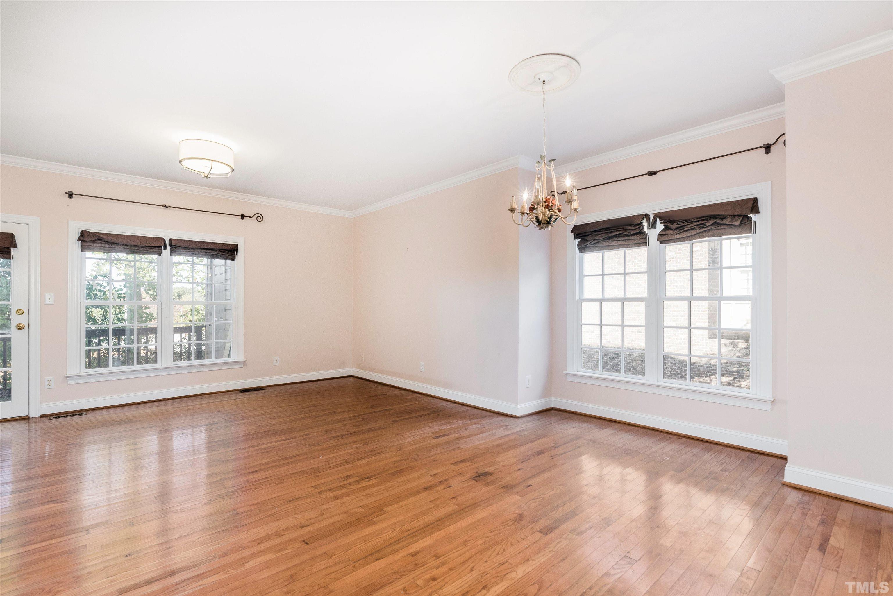 1347 Cameron View Court Raleigh, NC 27607 - Photo 14 of 23 an empty room with wooden floor and windows