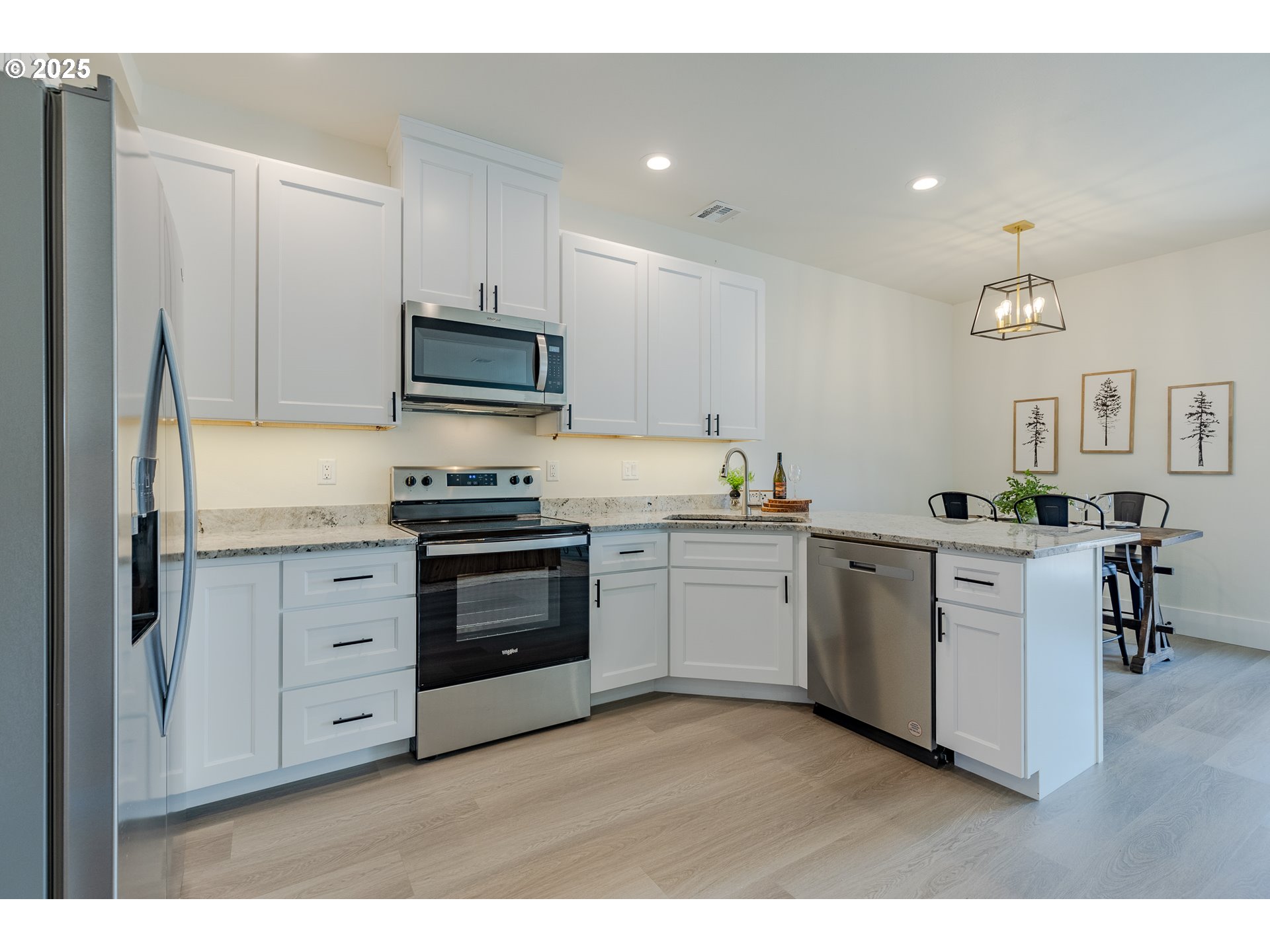 729 Periander Way Harrisburg, OR 97446 - Photo 10 of 24 a kitchen with white cabinets and stainless steel appliances