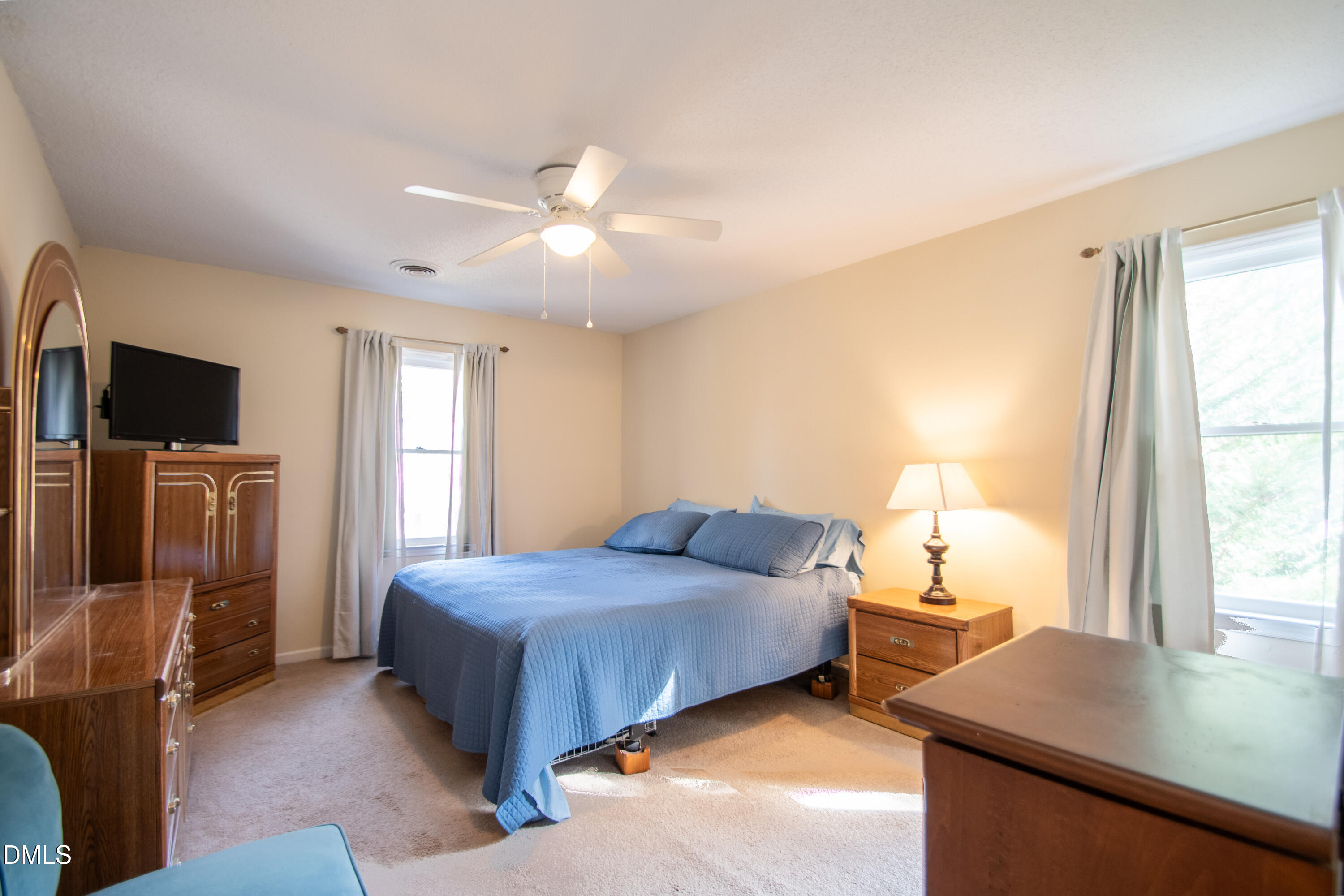 4700 Draper Road Raleigh, NC 27616 - Photo 16 of 31 a bedroom with a bed and a flat tv screen on dresser