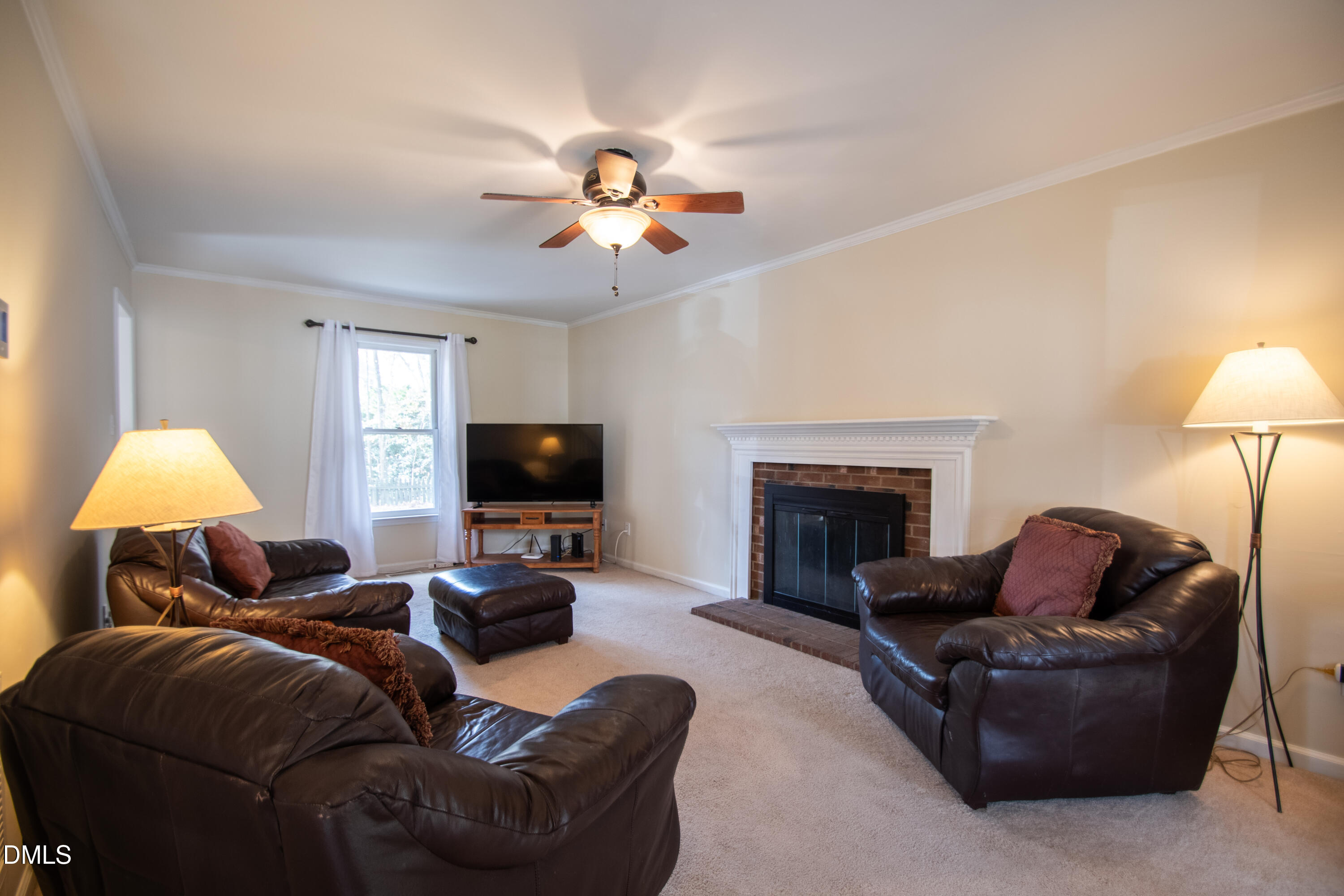 4700 Draper Road Raleigh, NC 27616 - Photo 4 of 31 a living room with furniture a fireplace and a flat screen tv