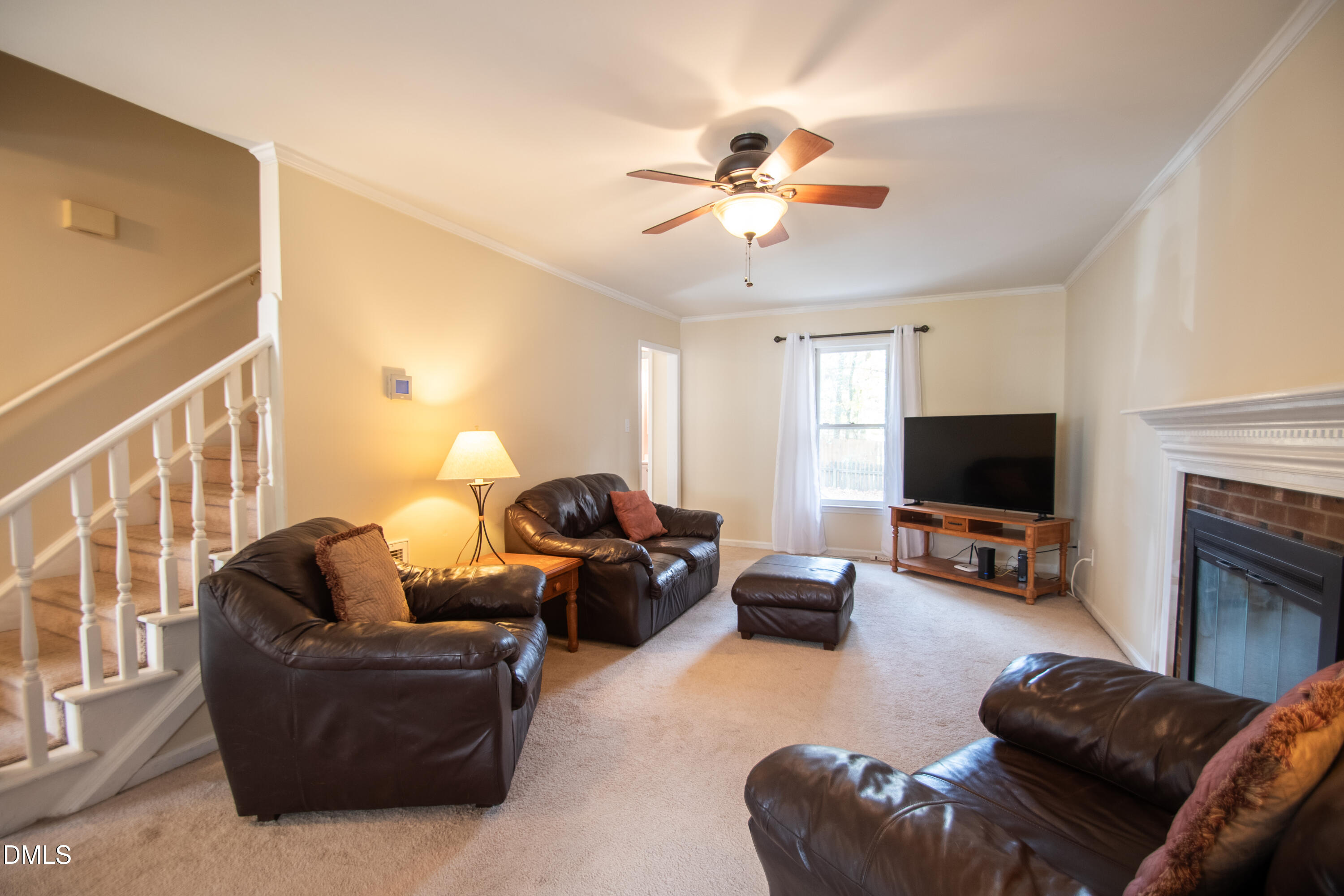 4700 Draper Road Raleigh, NC 27616 - Photo 5 of 31 a living room with furniture and a flat screen tv