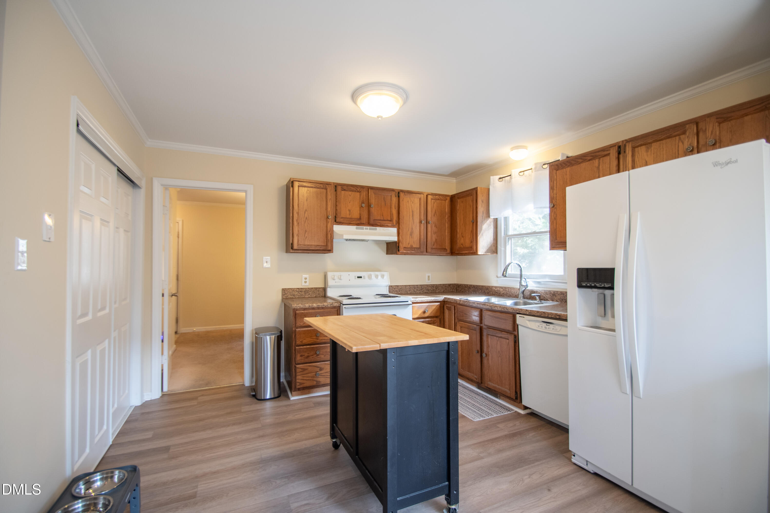 4700 Draper Road Raleigh, NC 27616 - Photo 9 of 31 a kitchen with stainless steel appliances granite countertop a refrigerator a sink dishwasher and a stove with wooden floor