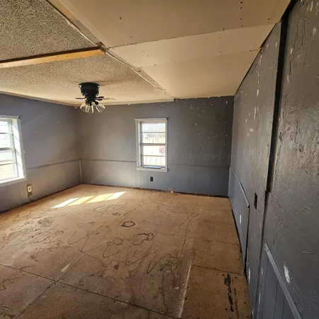 a view of empty room with windows