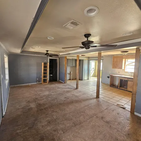 a view of livingroom with hardwood floor and a ceiling fan