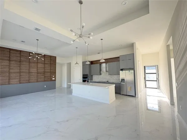a view of a kitchen with a sink and dishwasher cabinet with wooden floor