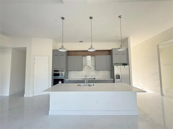 a view of kitchen island with stainless steel appliances