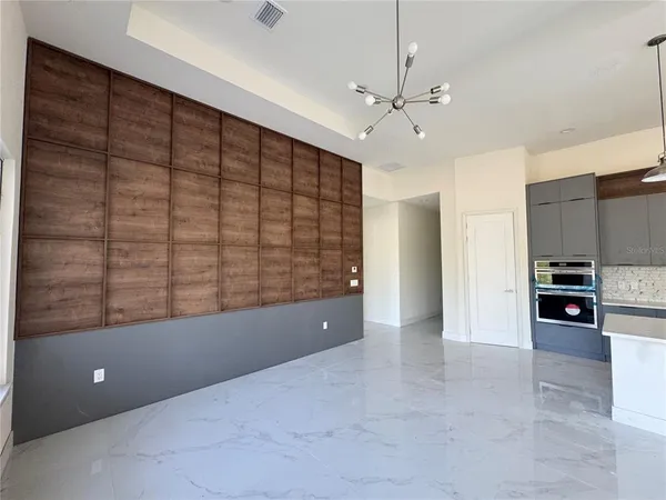 a view of empty room with a ceiling fan and window