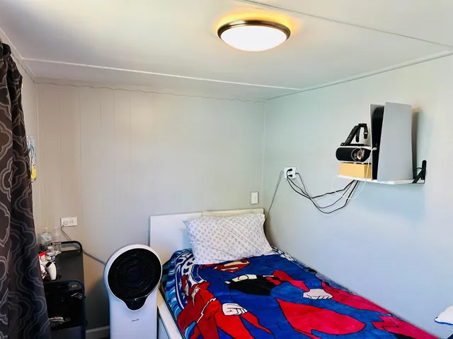 a bedroom with a bed and cabinets