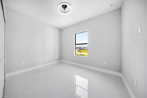 a large kitchen with stainless steel appliances kitchen island granite countertop a refrigerator a sink dishwasher a stove with white cabinets