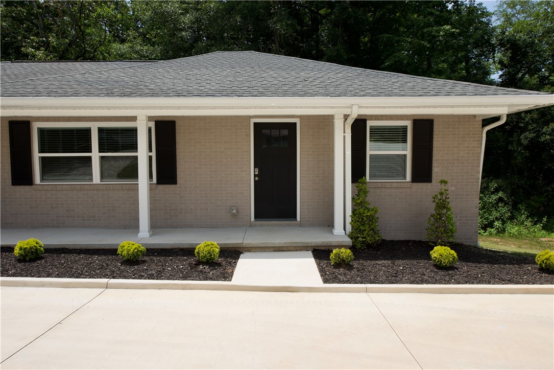 317 Pendleton Road Clemson, SC 29631 - Photo 8 of 36 A welcoming facade with a covered porch framed by tasteful landscaping and a paved entry.
