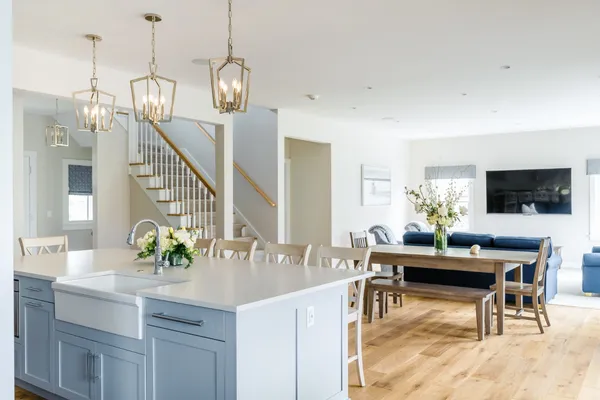 a view of dining room and kitchen island with furniture and wooden floor