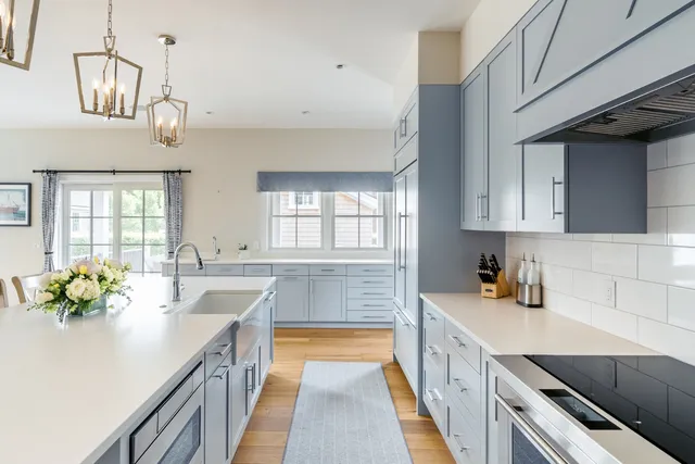 a living room with furniture a flat screen tv and a large window