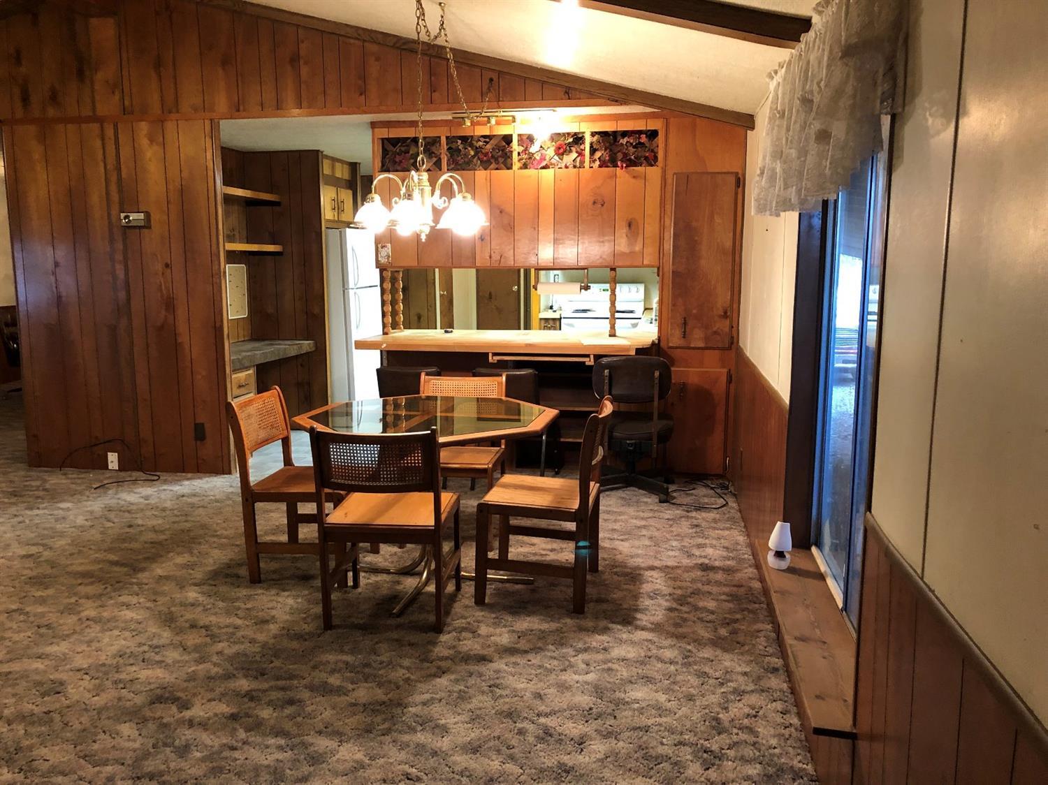 6226 East Evans Creek Road, Unit 15 Rogue River, OR 97537 - Photo 10 of 30 a dining room with furniture and window