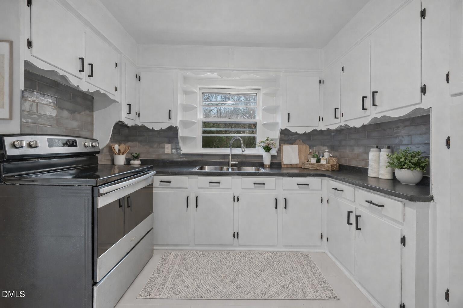 1811 Lazy Lane High Point, NC 27265 - Photo 15 of 44 a kitchen with granite countertop white cabinets and white appliances