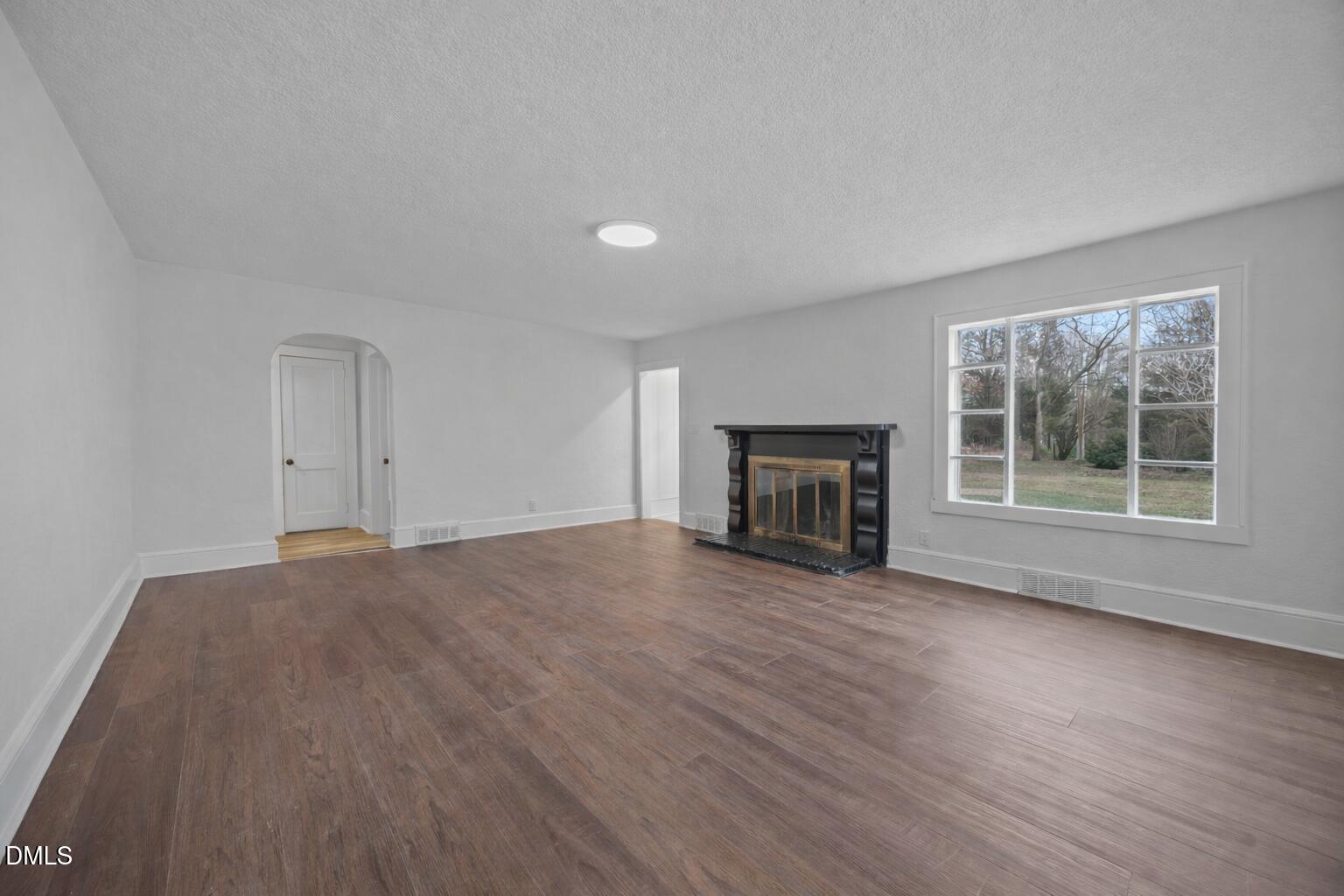 1811 Lazy Lane High Point, NC 27265 - Photo 9 of 44 a view of empty room with wooden floor and fireplace