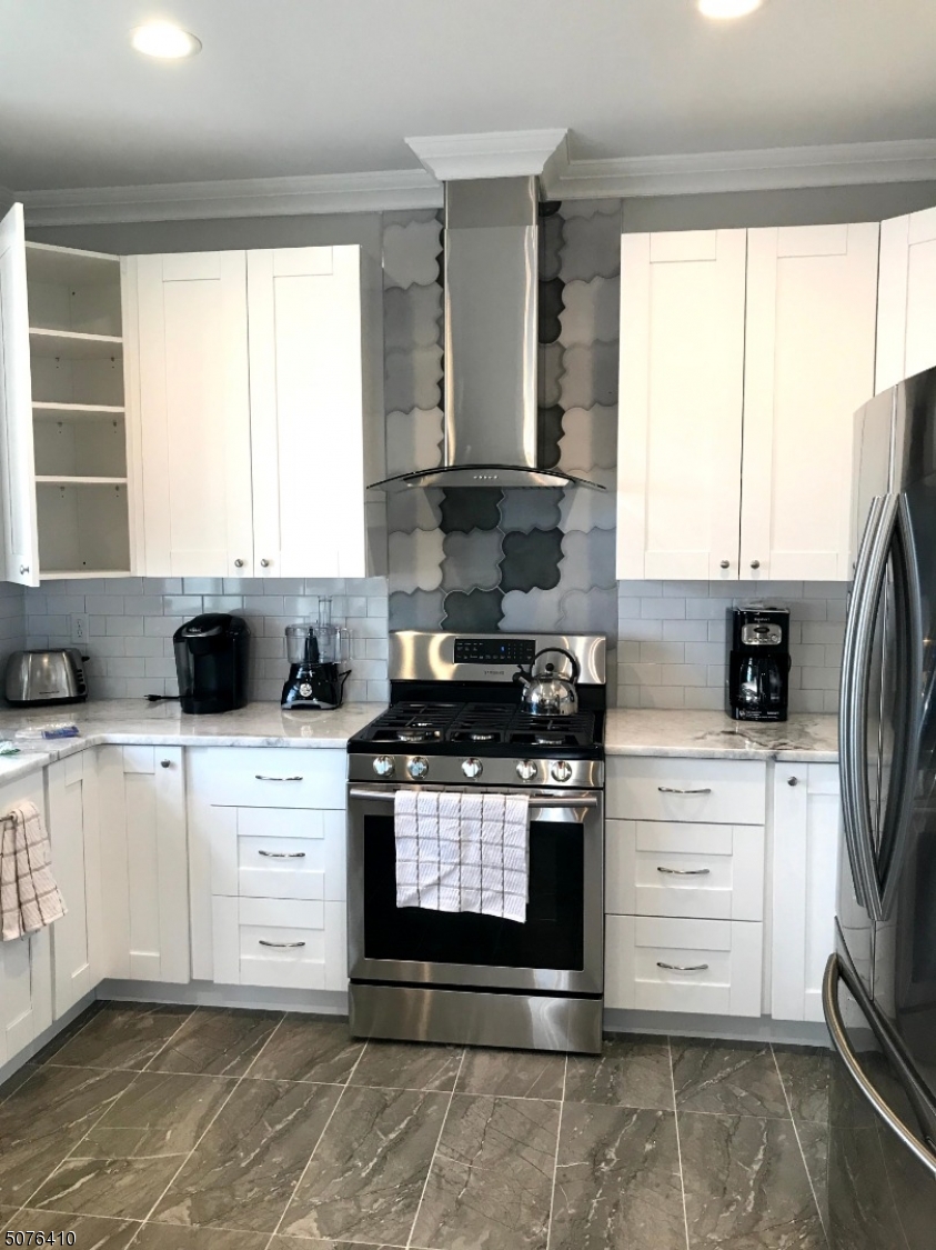 569 Springfield Avenue, Unit 5 Berkeley Heights, NJ 07922 - Photo 3 of 12 a kitchen with stainless steel appliances granite countertop a stove a sink and a white cabinets
