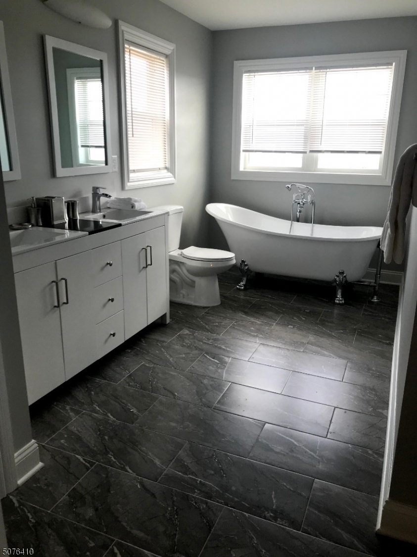 569 Springfield Avenue, Unit 5 Berkeley Heights, NJ 07922 - Photo 7 of 12 a spacious bathroom with a double vanity sink a toilet and a window