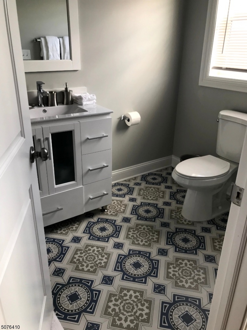 569 Springfield Avenue, Unit 5 Berkeley Heights, NJ 07922 - Photo 9 of 12 a bathroom with a toilet and a sink